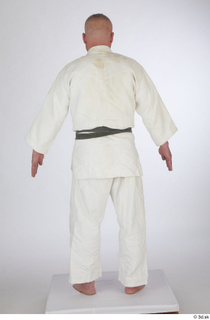 Yury A poses dressed sports standing white kimono dress whole…